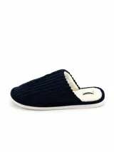 Pantufla abierta de pana azul marino con interior de corderito sintético color crema y suela plana.