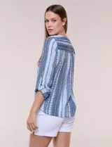 Blusa de gasa Zac & Rachel con estampado de rayas verticales en tonos rosados, amarillos y blancos. Presenta escote en V con cuello mao, cierre frontal con botones, un bolsillo aplicado en el pecho, mangas largas con presilla para regular el largo y detalle de nudo en el dobladillo inferior.