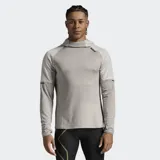 Buzo deportivo 2XU con capucha, confeccionado en tejido de punto doble con textura de gofre. Presenta mangas largas tipo raglán en un tono más claro, puños con orificio para el pulgar y logo de la marca estampado en el hombro.