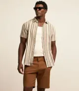 Bermuda masculina de sarga color rosa, corte slim, con bolsillos laterales y cierre con botón y cremallera.