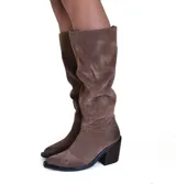 Bota de caña alta confeccionada en cuero gamuzado color marrón, con diseño de caña arrugada, punta cuadrada y taco bloque de altura media.