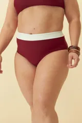 Bombacha de bikini tiro alto color negro con detalle de banda superior en color blanco.