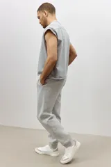 Pantalón de jogging gris de felpa liviana de mezcla de algodón con interior cepillado suave. Modelo con elástico revestido y cordón para ajustar en la cintura, bolsillos en las costuras laterales y puños acanalados.