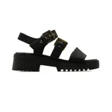 Sandalias negras de plataforma con suela track, tiras anchas con hebillas metálicas doradas envejecidas y sujeción en el talón.