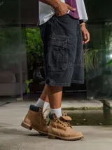 Bermuda cargo de gabardina con lavado negro, corte holgado y bolsillos cargo laterales.