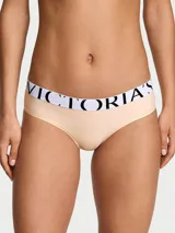 Braguita hiphugger de microfibra color marfil con pretina elástica ancha en contraste, en color blanco con el logotipo de Victoria's Secret estampado en negro.