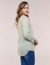Blusa verde claro con estampado paisley, escote en V con botones frontales y manga larga.