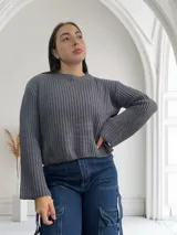 Sweater gris de punto con cuello redondo y mangas largas.