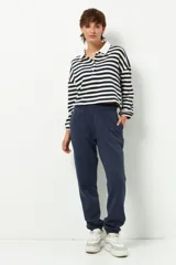 Pantalón de jogging negro de algodón con interior de felpa, bolsillos laterales, cintura elástica y puños ajustados.