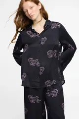 Pantalón ancho de seda viscosa color negro con estampado de tigres en color rosa. Cuenta con bolsillos laterales y elástico en la cintura.