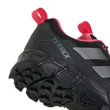 Championes de trekking Adidas Terrex Rockadia para mujer, de color negro con detalles en rosado y gris, confeccionados en malla y materiales sintéticos, con suela dentada para mayor tracción en terrenos difíciles.