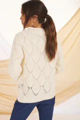 Sweater de punto calado color lila con cuello alto.