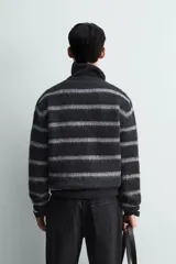 Jersey de punto con acabado cepillado, cuello redondo y manga larga. Presenta un corte boxy fit con terminaciones en rib.