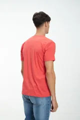 Remera de manga corta color coral con estampado en el pecho con la palabra "LEAP" en verde y un diseño de olas.