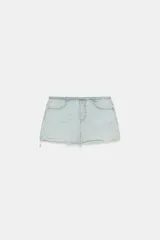 Falda mini de denim en tono celeste claro, tiro medio, con bolsillos delanteros, detalles de roturas y bajo deshilachado sin costuras.