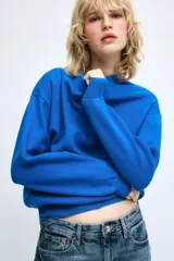 Jersey de punto color azul, con cuello redondo, manga larga y detalles de rib en cuello, puños y dobladillo.
