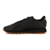 Championes Reebok Classic Leather negros con suela de goma color caramelo.
