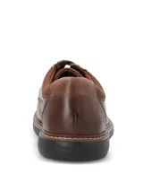 Zapato de cuero marrón con cordones, diseño clásico con costuras reforzadas y suela de goma EVA negra.