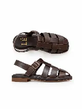 Sandalias Loop de cuero genuino color negro, con diseño de tiras entrelazadas, tira trasera y hebilla metálica.
