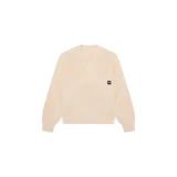 Sweater de punto color beige, de corte oversize, con cuello redondo acanalado y un diseño geométrico de rombos texturizados. Incluye una etiqueta negra con logo en el pecho.