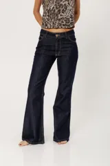 Pantalón de jean azul oscuro de corte bootcut, con cintura media entallada y proceso de suavizado.