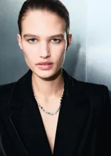 Blazer de terciopelo negro con diseño recto, cuello con solapas de muesca, cierre frontal cruzado con botones y bolsillos con solapa.