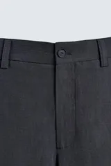 Pantalón de vestir negro, corte recto y relajado, con cintura elástica, cierre frontal con cremallera y botón, bolsillos delanteros y bolsillos traseros de plastrón.