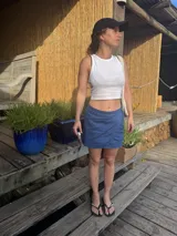 Minifalda azul de lino con diseño cruzado y cintura con cordón ajustable.