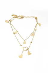 Tobillera dorada de doble cadena con dijes de corazones y bolitas.