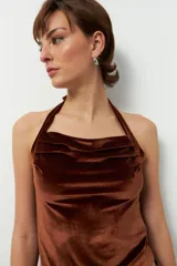 Top negro de terciopelo con escote halter, sin mangas y espalda descubierta.