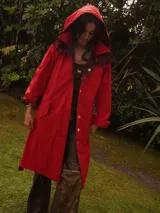 Trench coat impermeable de corte recto en color rojo, reversible con interior de viyela a cuadros, capucha desmontable y lazo para ajustar en la cintura.