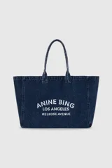 Bolso tipo tote bag de denim azul con doble asa superior y estampado frontal en blanco de la marca Anine Bing Los Angeles Melrose Avenue.