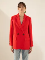 Blazer rojo de lino, cruzado, con solapas de muesca, dos botones de pasta a tono en el cruce y botones en los puños.
