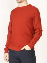 Sweater color ladrillo con escote redondo y punto retenido frontal.