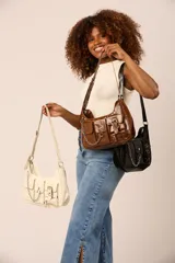 Cartera tipo baguette con múltiples bolsillos frontales, cierre de hebilla y detalle de cadena metálica decorativa. Cuenta con correa ajustable para llevar al hombro.