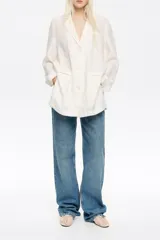 Chaqueta estilo sastre color blanco, confeccionada en mezcla de lino. Presenta escote con solapas, manga larga recta con abertura en puño, cierre con botonadura frontal y bolsillos con vivo.