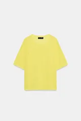 Top de punto fino color amarillo pastel, con cuello redondo y mangas cortas.