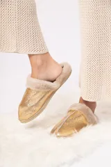 Pantuflas doradas de cuero ovino con interior de lana natural.