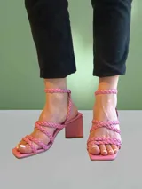 Sandalias de cuero sintético color rosa, con tiras trenzadas, taco alto y plataforma triangular.
