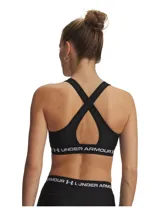 Top deportivo Under Armour modelo Crossback Mid, color negro, confeccionado en tejido HeatGear de doble capa con soporte estratégico para actividades de impacto medio. Cuenta con banda elástica inferior con el logotipo de la marca impreso en blanco.