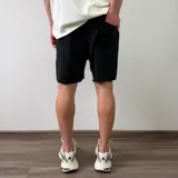 Short de algodón color beige melange, de diseño cómodo y holgado con bolsillos laterales y terminación descosida en las perneras.