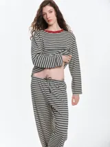Remera de dormir de corte oversize con estampado de rayas horizontales, confeccionada en algodón con elastano. Presenta cuello redondo en rib de color rojo contrastante y mangas largas.