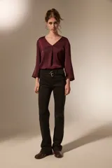 Pantalon de corte flare con cintura media y cinturón integrado con hebilla metálica.