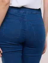 Jegging de denim azul oscuro con tiro medio-alto, cintura elástica ancha y pierna sutilmente entallada con terminación bootcut. Cuenta con bolsillos delanteros simulados y bolsillos aplicados en la parte trasera.