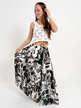 Falda larga de algodón con estampado floral en tonos azul y blanco. Tiene elástico en la cintura y viene con un cinto de rafia elastizado, desmontable.