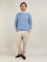 Sweater de punto inglés color celeste con cuello redondo, manga larga y corte regular fit. Cuenta con un pequeño logo bordado en el pecho.