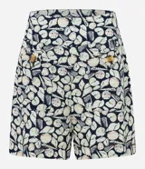 Short de tiro alto confeccionado en viscolino con estampa de caracoles, bolsillos delanteros con botones y detalle de pespunte.