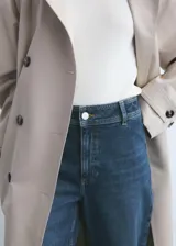 Pantalón de jean tiro alto con corte culotte y pernera ancha. Presenta cierre frontal con cremallera y botón, trabillas para cinturón y bolsillos traseros.