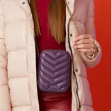 Bandolera mini color púrpura, con diseño acolchado en forma de chevron y correa de cadena dorada regulable. Tiene cierre superior y bolsillo interno con cierre.