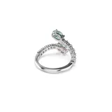 Anillo abierto bañado en rodio de la colección Ariana Grande x Swarovski. Presenta una banda decorada con circonitas transparentes en pavé y dos piedras principales en los extremos: una circonita ovalada de color verde y una circonita en forma de pera de color rosa.